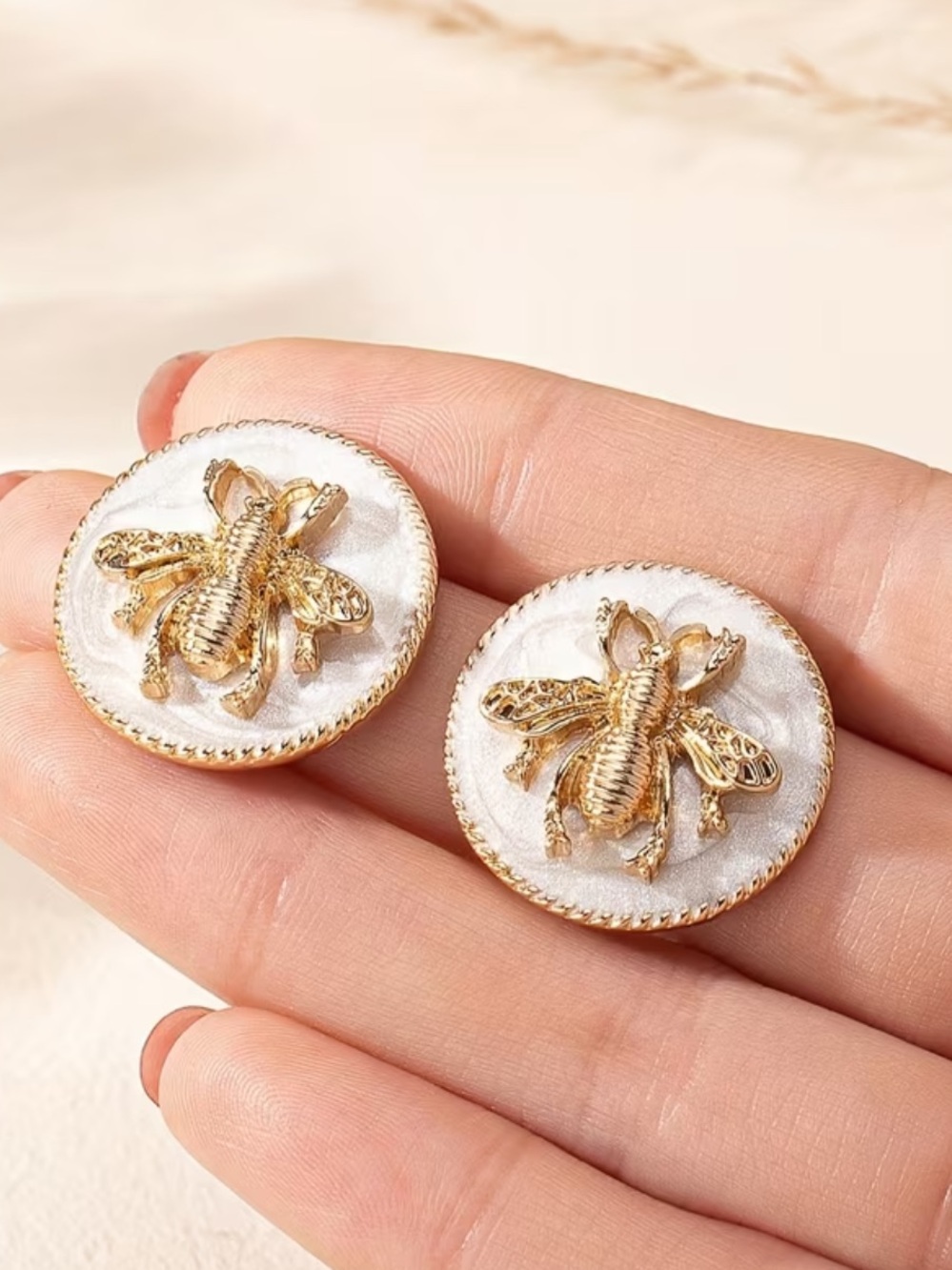 Gold and white bee studs
